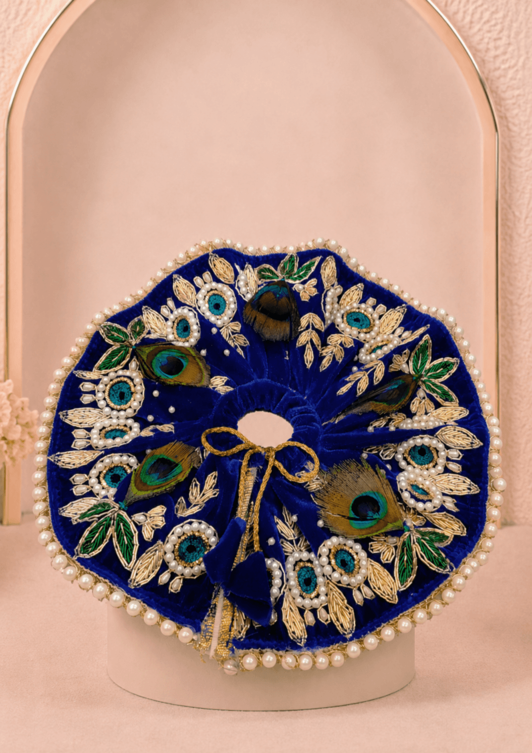 Neelambar Set Laddu Gopal Ji poshak featuring a royal blue circular flare, gold embroidered floral motifs, peacock feathers and pearl embellishments