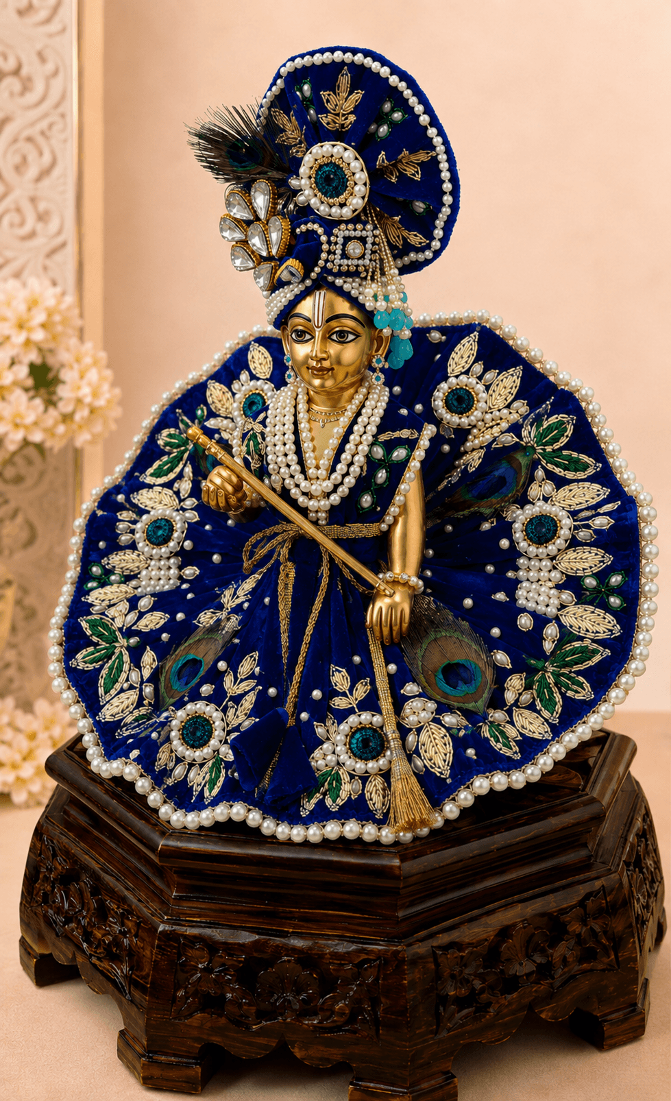 Side view of Neelambar Set Laddu Gopal Ji dress featuring royal blue fabric, golden embroidery, peacock feather detailing, pearl embellishments and designer mukut