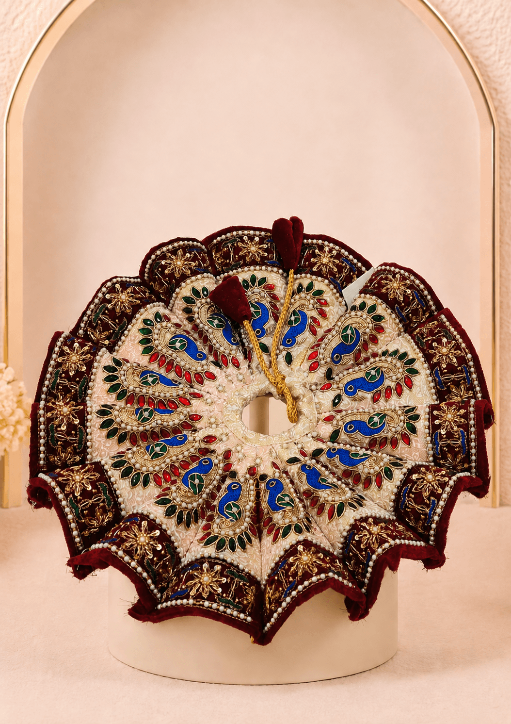 Rajsi Shyam Set Laddu Gopal Ji poshak featuring an ivory circular flare, burgundy embroidered border, colorful peacock motifs, gold detailing and pearl work